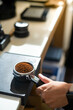 © pariwatpannium - Coffee grinder with ground coffee in coffee shop