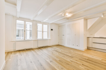 an empty living room with wood floors and white trim on the walls in this photo is taken from the in