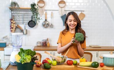 Wall Mural - Portrait of beauty body slim healthy asian woman having fun cooking and preparing cooking vegan food healthy eat with fresh vegetable salad on counter in kitchen at home.Diet.Fitness, healthy food