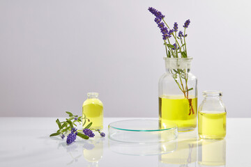 Wall Mural - Several vases filled with yellow fluid are arranged around a transparent podium. Concept scene stage showcase for new product that extracted from Lavender (Lavandula)