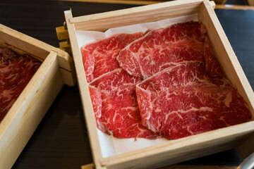 Wall Mural - Premium quality beef for cooking sukiyaki meal served on wood box. Close up