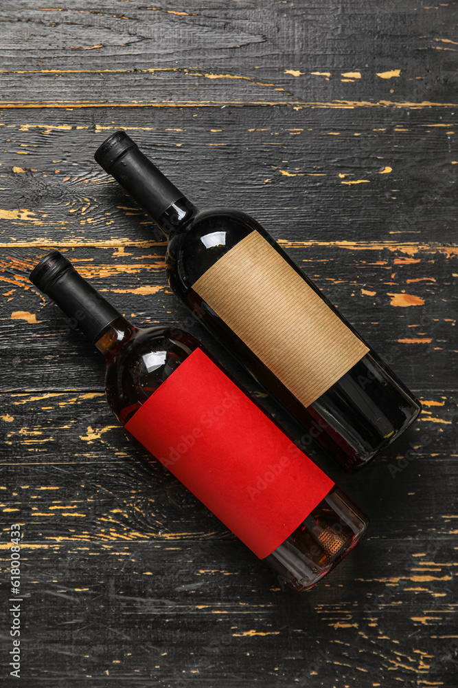 Bottles of exquisite wine on dark wooden background