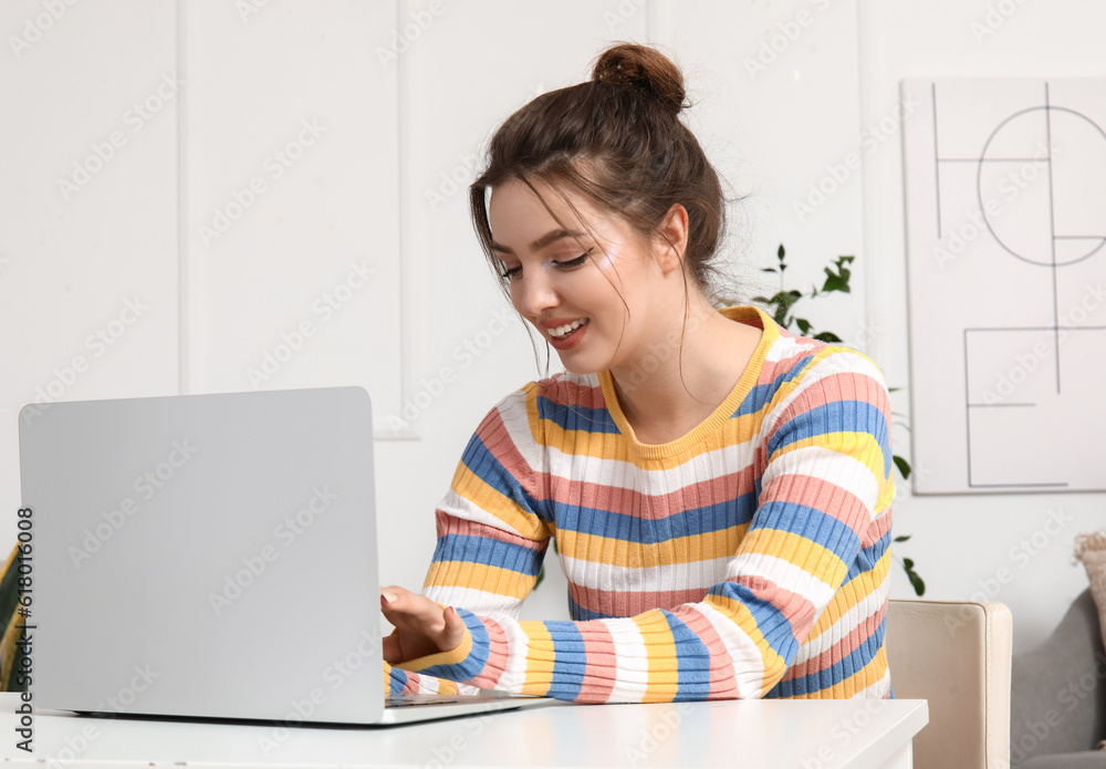 Female freelancer working with laptop at table in office