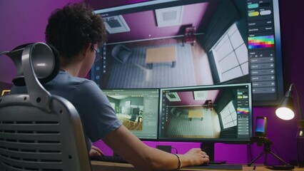 Young 3D designer creates modern house interior, works on design project at home office. Teenager trains 3D modeling and planning on computer and big digital screen with software interface and tools.