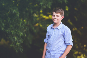 Handsome Teenager Boy Poses Outdoors, Exuding Confidence and Style in a Captivating Portrait. Happy Preteen Child.