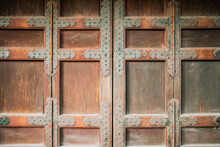 Background Texture Of A Massive Medieval Metal Studded Wooden Door In A Castle As Copy Space.