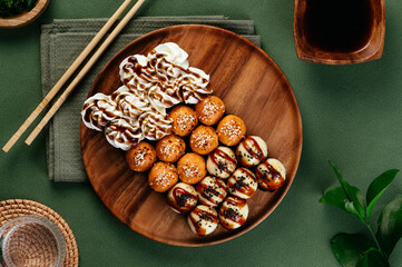 Wall Mural - set of Asian sushi rolls with cheese caps on a wooden plate