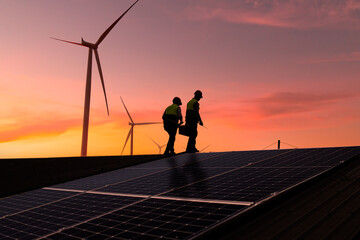 Silhouette engineer working on solar cell plant with windmill field .Solar cell smart grid and windmill are ecology energy renewable sunlight alternative green power environment factory 