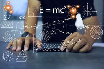 Wall Mural - physics equations floating in the background on tables, representing the learning teaching or scient
