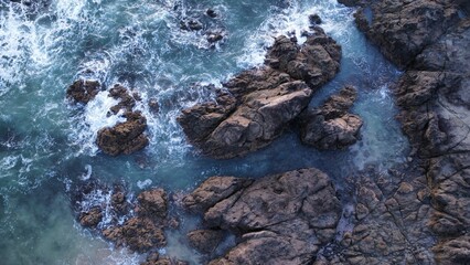 Sticker - Aerial view of an idyllic landscape with a body of water and rocky outcrops