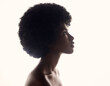 Hair care, silhouette and profile of black woman with afro hairstyle, beauty and skincare on grey background. Natural haircare, cosmetics and face of African model with skin glow and shine in studio.