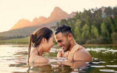 Poster - Man, woman and hug with swim in lake, sunset and forest with love, bonding and vacation in summer. Young happy couple, outdoor and water for holiday together in sunshine with care, laugh or freedom