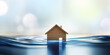 Nature disaster and business insurance concept: model wooden house submerged under water.  