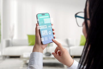 User interface and experience concept app on smart phone in woman hands. Clean design with flying app modules concept
