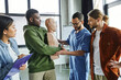 © LIGHTFIELD STUDIOS - medical instructor assisting african american man practicing life-saving techniques in case of choking on CPR manikin near multiethnic participants, emergency situations preparedness concept