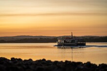 Wooden Ferry Boat On A River Crossing At Sunset In Australia
