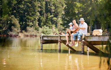 Wall Mural - Father, grandfather and child fishing at lake together for fun bonding or peaceful time in nature outdoors. Dad, grandpa and kid enjoying life, catch or fish with rod by water pond or river in forest