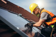 An eco friendly solar panel being fitted to a residential roof by an engineer