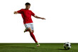 © master1305 - Young man in red uniform, football player in motion, playing, kicking ball on sports field against white background. Concept of professional sport, action, lifestyle, competition, hobby, training, ad
