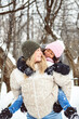 attractive mother with cute child daughter in winter forest