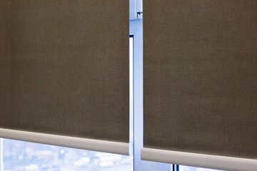 Poster - Roller blinds closeup on the window. Selective fokus. Motorized roller shades. Gray color, texture material. Two fabric webs through an intermediate bracket.