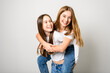 Two Young pre teen best friend girl on studio white