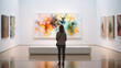 © Keitma - Back of an adult woman looking at a modern art painting in a gallery