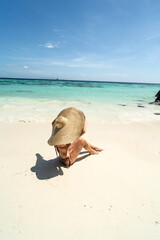 Wall Mural - Beautiful woman sunbathing and relaxing at amazing tropical beach in a sunny summer day. Koh Lipe island