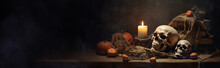 Wizard's Desk. A Desk Lit By Candle Light. A Human Skull, Old Books On Sand Surface. Halloween Still-life Background With A Different Elements On Dark  Background. With Copy Space