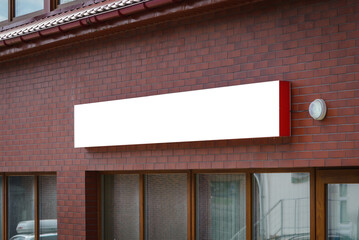 Wall Mural - Blank white store entrance mockup, glass brick wall. Empty exterior signage on business center mockup. Clear display or lightbox on edifice for boutique mokcup template.