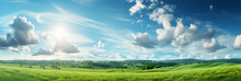 Beautiful Panoramic Natural Landscape Of A Green Field With Grass Against A Blue Sky With Sun. Spring Summer Blurred Background