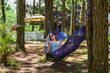 © Tatiana - Young brunette woman resting in hammock in forest