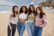 © PintoArt - happy multiracial women on the beach partying