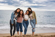 © PintoArt - group of multiracial diverse female friends together on the beach
