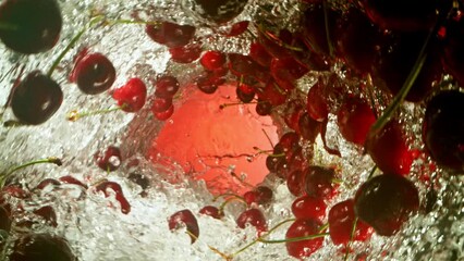 Fototapete - Super Slow Motion of Water Wave with Cherries. Water Surf Wave Rotating Around and Creating Tunnel Shape. Filmed on high speed cinema camera, 1000 fps.