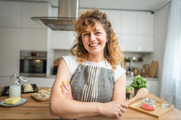 One happy young adult caucasian woman wear apron in the kitchen smile