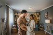 © Miljan Živković - Happy couple adult caucasian man woman husband and wife dance at home