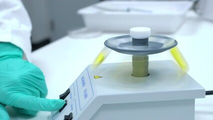 Wall Mural - Scientist puts a test tube to micro spin for shaking or centrifugation of samples for DNA analysis. 