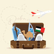 Isolated open travel suitcase with uae flags and famous landmarks Vector