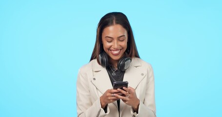 Wall Mural - Happy woman, phone and texting in studio, laughing and reading funny email or message on blue background. Smartphone, joke and female laugh at silly comment, post or online comic or streaming meme