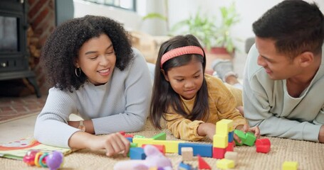 Wall Mural - Building blocks, bonding and parents helping with their kid on the floor in the living room. Happy, smile and girl child learning with toys with young mother and father in their modern family home.