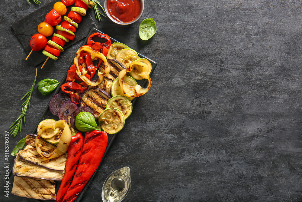 Plate with tasty grilled vegetables on black background