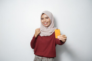 Wall Mural - Happy young Asian woman holding credit card with hand gesture success on white background