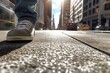 A foot stepping onto a busy city sidewalk
