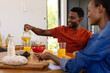 © WavebreakMediaMicro - Happy african american couple enjoying breakfast in dining room
