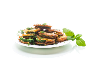 Sticker - zucchini fried in circles in batter with herbs, in a plate.