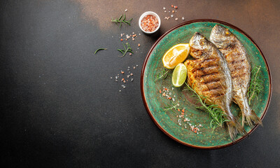 Wall Mural - Baked Dorado Sea Bream fish on plate. Healthy food concept. place for text, top view