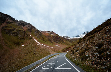 Asphalt road in Alps mountains. Road trip concept. Beautiful landscape.