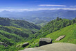 © athapet - Beautiful scenery of deep valley and green trees on the mountains with blue sky background
