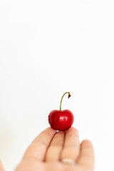 Sticker - Vibrant single red cherry isolated on a white background